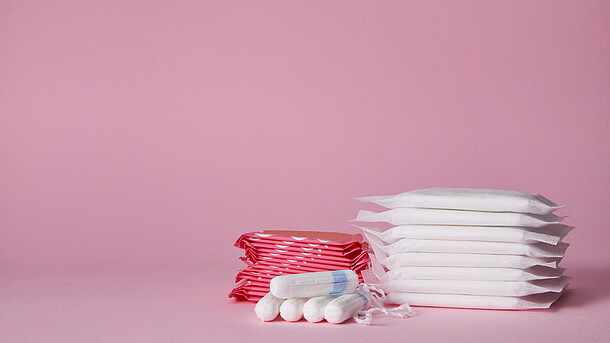 Binden und Tampons vor rosa Hintergrund